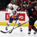 
              New York Islanders' Kyle Palmieri (21) tries to shoot the puck past Carolina Hurricanes' Jaccob Slavin (74) during the third period of an NHL hockey game in Raleigh, N.C., Friday, April 8, 2022. (AP Photo/Karl B DeBlaker)
            
