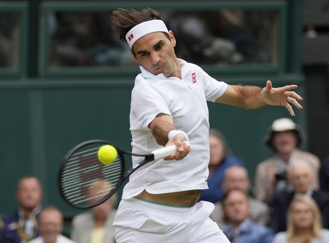 FILE - Switzerland's Roger Federer returns the ball to Italy's Lorenzo Sonego on day seven of the W...