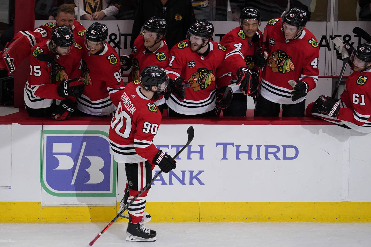 Chicago Blackhawks center Tyler Johnson (90) celebrates with teammates after scoring goal in a shoo...