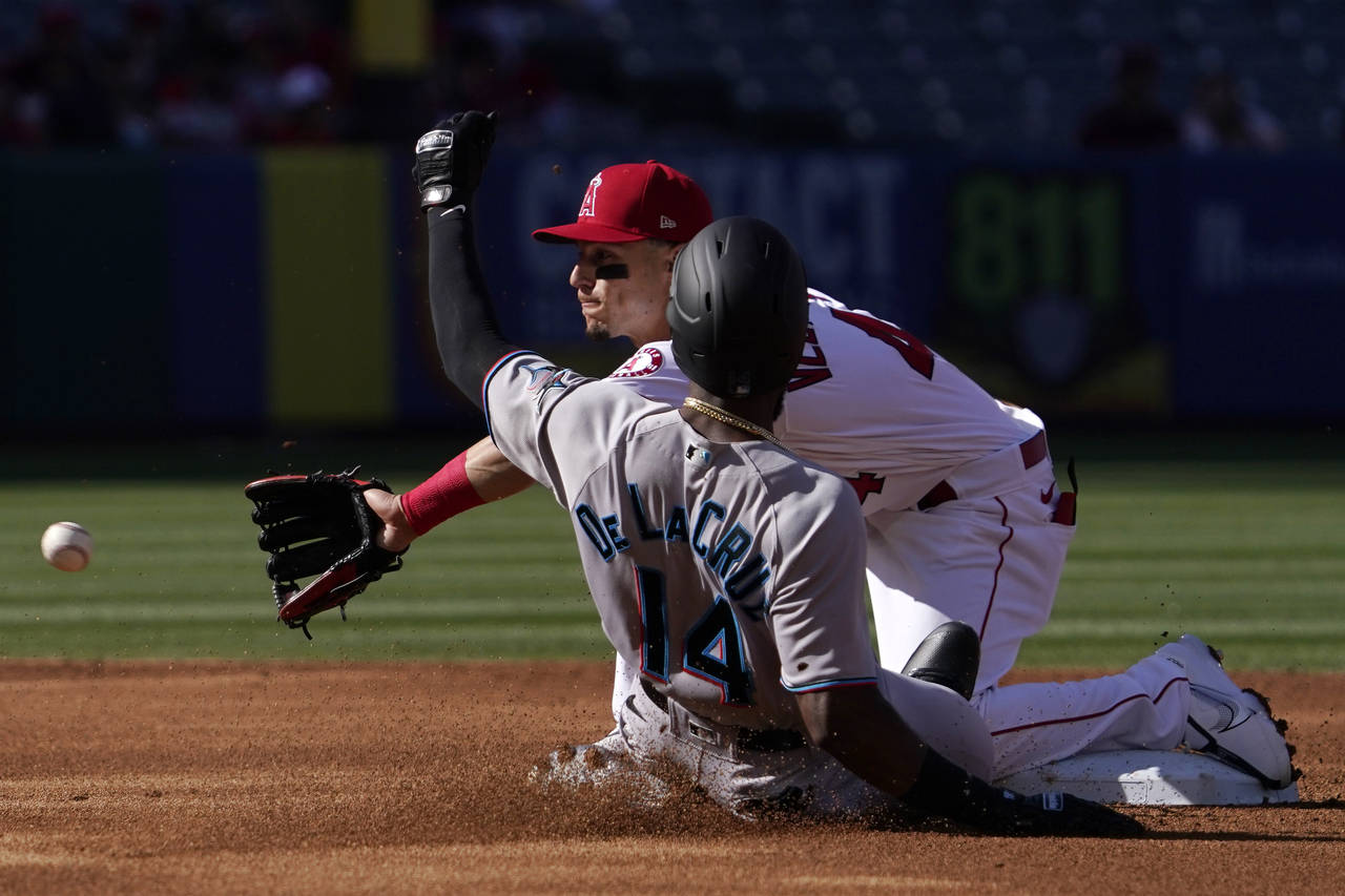 Miami Marlins' Bryan De La Cruz, left, is safe at second on a passed ball as Los Angeles Angels sho...