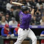 
              Colorado Rockies' C.J. Cron watches his three-run home run off Philadelphia Phillies relief pitcher Jeurys Familia during the seventh inning of a baseball game Tuesday, April 19, 2022, in Denver. (AP Photo/David Zalubowski)
            