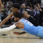 
              Sacramento Kings guard Josh Jackson, top, reaches for a loose ball over Los Angeles Clippers guard Paul George during the second half of an NBA basketball game Saturday, April 9, 2022, in Los Angeles. (AP Photo/Marcio Jose Sanchez)
            