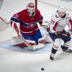 
              Montreal Canadiens goaltender Sam Montembeault (35) and Washington Capitals right wing T.J. Oshie (77) look to the puck during the second period of an NHL hockey game Saturday, April 16, 2022, in Montreal. (Peter McCabe/The Canadian Press via AP)
            