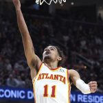 
              Atlanta Hawks' Trae Young shoots during the second half of the team's NBA play-in basketball game against the Cleveland Cavaliers on Friday, April 15, 2022, in Cleveland. (AP Photo/Nick Cammett)
            