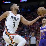 
              New Orleans Pelicans guard CJ McCollum (3) goes up to shoot next to Phoenix Suns guard Landry Shamet (14) in the first half of Game 4 of an NBA basketball first-round playoff series in New Orleans, Sunday, April 24, 2022. (AP Photo/Matthew Hinton)
            