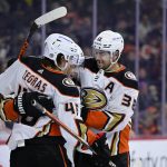 
              Anaheim Ducks' Troy Terry, center, is congratulated by Trevor Zegras, left, and Derek Grant after Terry scored a goal past Philadelphia Flyers goaltender Martin Jones during the third period of an NHL hockey game, Saturday, April 9, 2022, in Philadelphia. (AP Photo/Derik Hamilton)
            