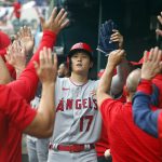 
              Los Angeles Angels designated hitter Shohei Ohtani (17) is greeted in the dugout after scoring in the third inning against the Texas Rangers during a baseball game on Saturday, April 16, 2022, in Arlington, Texas. (AP Photo/Richard W. Rodriguez)
            