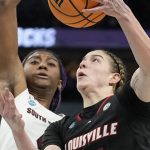
              Louisville's Emily Engstler tries to get past South Carolina's Aliyah Boston during the first half of a college basketball game in the semifinal round of the Women's Final Four NCAA tournament Friday, April 1, 2022, in Minneapolis. (AP Photo/Eric Gay)
            