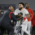 
              FILE - Defensive tackle Haskell Garrett, right, runs a drill during Ohio State football pro day in Columbus, Ohio, March 23, 2022. Josh Paschal and Garrett count themselves among the lucky ones. They understand only a tiny fraction of football players get a chance to play in the NFL, and even fewer overcome frightening experiences like theirs to become legitimate draft prospects. (AP Photo/Paul Vernon, File)
            