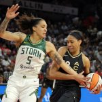 LAS VEGAS, NEVADA - MAY 08: A'ja Wilson #22 of the Las Vegas Aces drives against Gabby Williams #5 of the Seattle Storm during their game at Michelob ULTRA Arena on May 08, 2022 in Las Vegas, Nevada. The Aces defeated the Storm 85-74. NOTE TO USER: User expressly acknowledges and agrees that, by downloading and or using this photograph, User is consenting to the terms and conditions of the Getty Images License Agreement. (Photo by Ethan Miller/Getty Images)