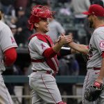 
              Los Angeles Angels catcher Max Stassi, center, celebrates with relief pitcher Ryan Tepera after they defeated the Chicago White Sox in a baseball game in Chicago, Sunday, May 1, 2022. (AP Photo/Nam Y. Huh)
            