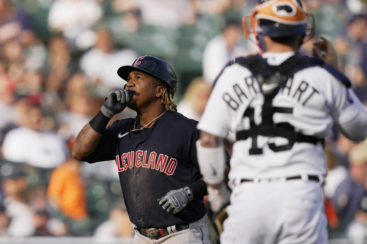 Cleveland Guardians' Jose Ramirez looks skyward as he passes Detroit Tigers catcher Tucker Barnhart...