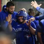 
              Toronto Blue Jays' Alejandro Kirk, center, celebrates in the dugout after scoring off a double hit by Lourdes Gurriel Jr. during the fifth inning of a baseball game against the Los Angeles Angels in Anaheim, Calif., Friday, May 27, 2022. (AP Photo/Ashley Landis)
            