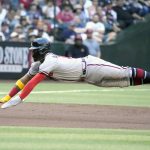 
              Atlanta Braves Ronald Acuna Jr. dives into third base after going from first to third on a single by Dansby Swanson against the Arizona Diamondbacks in the first inning of a baseball game, Monday, May 30, 2022, in Phoenix. (AP Photo/Rick Scuteri)
            