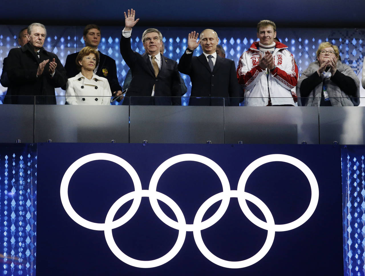 FILE - International Olympic Committee (IOC) President Thomas Bach, third from left, and Russian Pr...