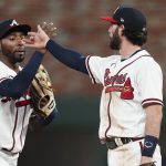 
              Atlanta Braves' Dansby Swanson right, and Travis Demeritte celebrate after the team's win over the Philadelphia Phillies in a baseball game Wednesday, May 25, 2022, in Atlanta. (AP Photo/John Bazemore)
            