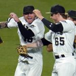 
              Pittsburgh Pirates outfielders Ben Gamel, left, Jack Suwinski (65), and Bryan Reynolds, rear, celebrate after getting the final out of win over the Colorado Rockies in a baseball game in Pittsburgh, Monday, May 23, 2022. (AP Photo/Gene J. Puskar)
            