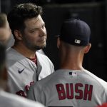 
              Boston Red Sox starting pitcher Rich Hill, left, listens to pitching coach Dave Bush in the dugout after the fourth inning of the team's baseball game against the Chicago White Sox on Wednesday, May 25, 2022, in Chicago. (AP Photo/Charles Rex Arbogast)
            