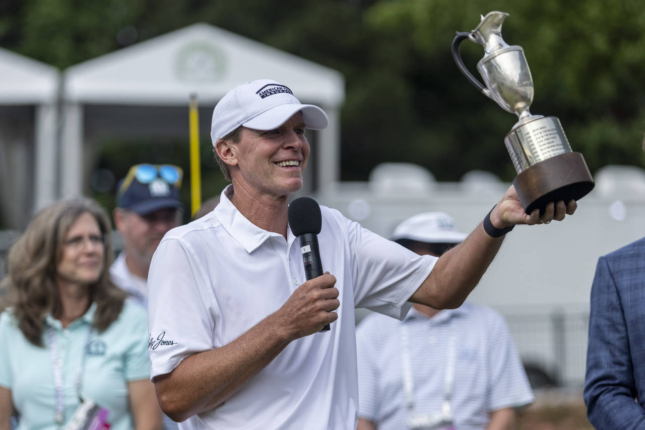 Steve Stricker hoists the trophy on the 18th hole after winning the Regions Tradition, a PGA Tour C...