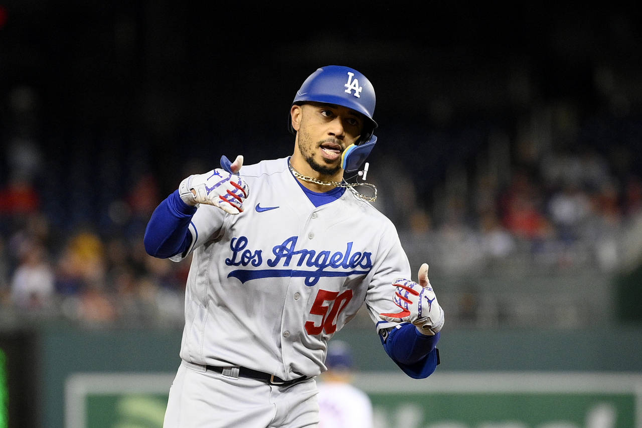 Los Angeles Dodgers' Mookie Betts celebrates his home run as he rounds the bases during the fourth ...