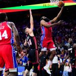 
              Philadelphia 76ers' James Harden, right, goes up for a shot against Miami Heat's Tyler Herro (14) during the second half of Game 4 of an NBA basketball second-round playoff series, Sunday, May 8, 2022, in Philadelphia. (AP Photo/Matt Slocum)
            