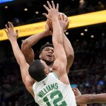 
              Milwaukee Bucks forward Giannis Antetokounmpo, center top, shoots at the basket as Boston Celtics forward Grant Williams (12) defends during the first half of Game 7 of an NBA basketball Eastern Conference semifinals playoff series, Sunday, May 15, 2022, in Boston. (AP Photo/Steven Senne)
            