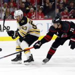 
              Boston Bruins' Brad Marchand (63) competes for the puck against Carolina Hurricanes' Sebastian Aho (20) during the first period of Game 2 of an NHL hockey Stanley Cup first-round playoff series in Raleigh, N.C., Wednesday, May 4, 2022. (AP Photo/Karl B DeBlaker)
            