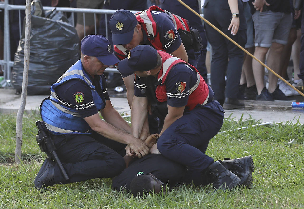 Police officers apprehend a Feyenoord supporter before the Europa Conference League final soccer ma...