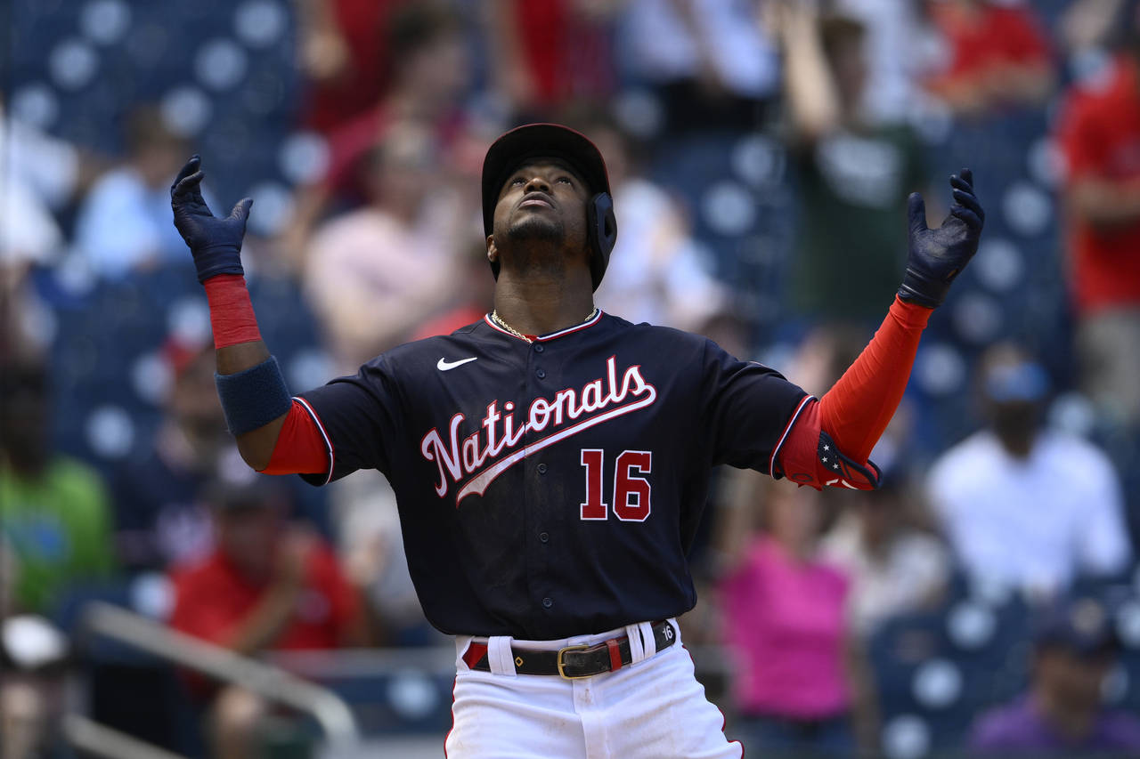 Washington Nationals' Victor Robles celebrates his three-run home run during the fourth inning of t...