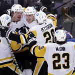 
              Pittsburgh Penguins center Evgeni Malkin (71) celebrates with teammates after scoring against the New York Rangers in the third overtime of Game 1 of an NHL hockey Stanley Cup first-round playoff series, Tuesday, May 3, 2022, in New York. The Penguins won 4-3. (AP Photo/Adam Hunger)
            