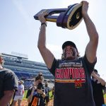
              Maryland face off specialist Luke Wierman lifts the championship trophy after Maryland beat Cornell 9-7 in the NCAA college men's lacrosse championship game, Monday, May 30, 2022, in East Hartford, Conn. (AP Photo/Bryan Woolston)
            