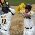 
              San Diego Padres' Luke Voit, right, celebrates with Jurickson Profar (10) after hitting a three-run home run against the Pittsburgh Pirates during the sixth inning of a baseball game Friday, May 27, 2022, in San Diego. (AP Photo/Gregory Bull)
            