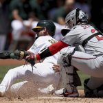 
              Oakland Athletics' Ramon Laureano (22) is tagged out at home plate by Minnesota Twins' Ryan Jeffers (27) in the second inning of a baseball game in Oakland, Calif., on Wednesday, May 18, 2022. (AP Photo/Scot Tucker)
            