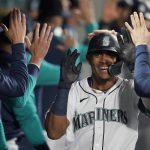 
              Seattle Mariners' Julio Rodriguez is congratulated in the dugout after hitting a two-run home run against the Oakland Athletics during the fifth inning of a baseball game Tuesday, May 24, 2022, in Seattle. (AP Photo/Ted S. Warren)
            