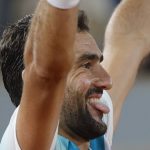 
              Croatia's Marin Cilic sticks his tongue out after defeating Russia's Daniil Medvedev during their fourth round match of the French Open tennis tournament at the Roland Garros stadium Monday, May 30, 2022 in Paris. Cilic won 6-2, 6-3, 6-2. (AP Photo/Jean-Francois Badias)
            