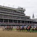 
              Horses come through the first turn during the 148th running of the Kentucky Derby horse race at Churchill Downs Saturday, May 7, 2022, in Louisville, Ky. Rich Strike, left rear, ridden by Sonny Leon, won the race. (AP Photo/Charlie Neibergall)
            