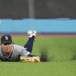
              Seattle Mariners right fielder Dylan Moore (25) makes a diving catch to out Toronto Blue Jays left fielder Raimel Tapia during the fourth inning of a baseball game in Toronto, Monday, May 16, 2022. (Nathan Denette/The Canadian Press via AP)
            