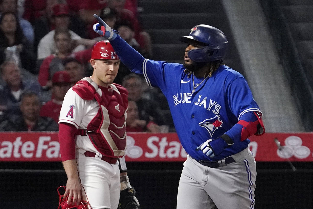 Toronto Blue Jays' Vladimir Guerrero Jr., right, gestures after hitting a solo home run as Los Ange...