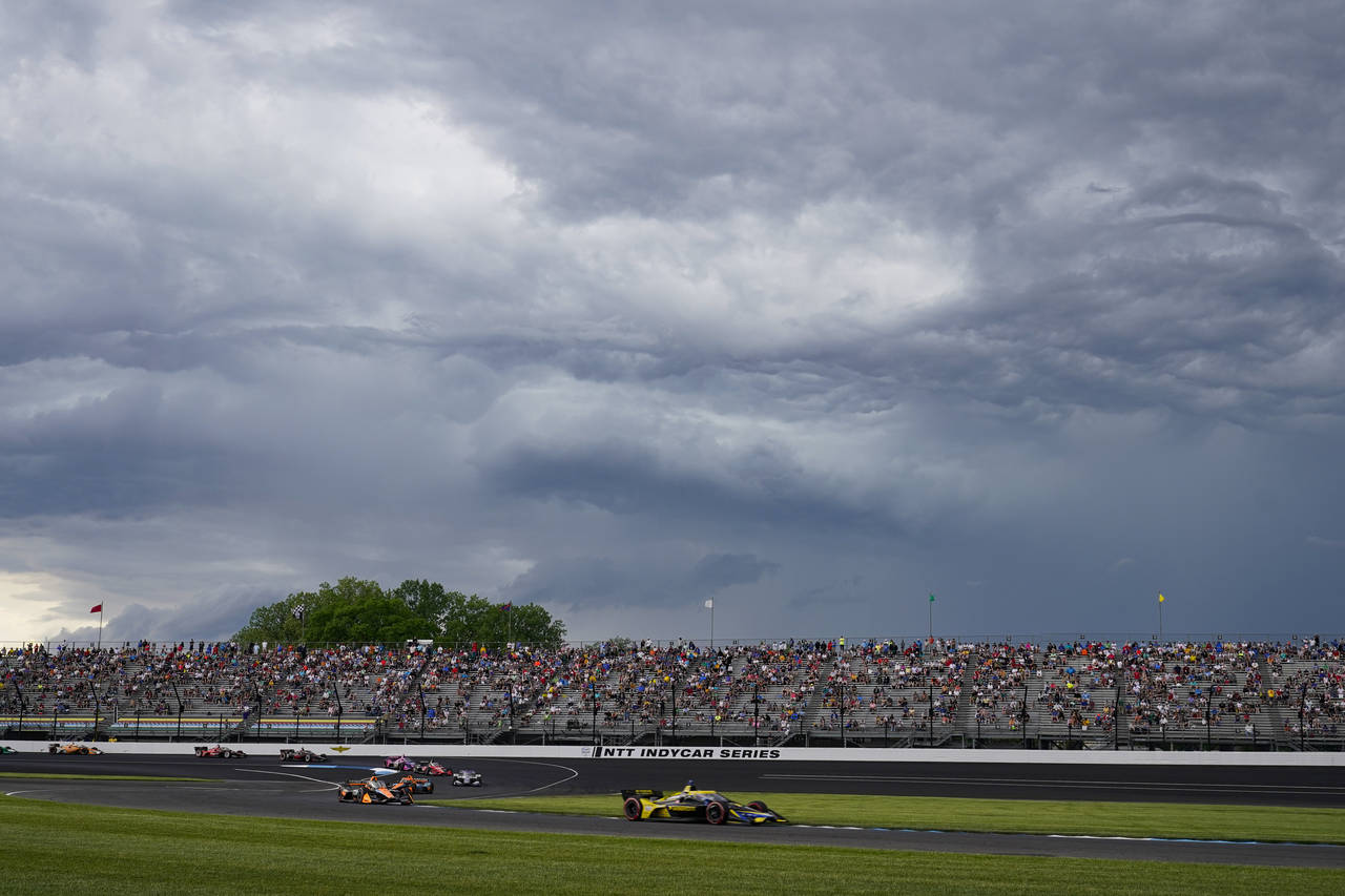 Colton Herta leads as storm clouds gather on his way to winning the IndyCar Grand Prix auto race at...