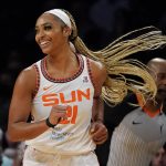 
              Connecticut Sun guard DiJonai Carrington (21) smiles as she runs up the court in the second half during a WNBA basketball game against the New York Liberty, Tuesday, May 17, 2022, in New York. (AP Photo/John Minchillo)
            