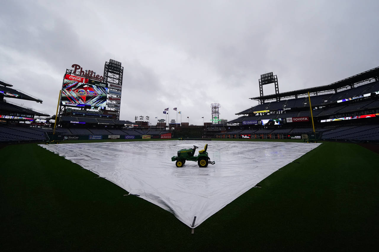 A tarp is seen covering the field as a storm postpones a baseball game between the Philadelphia Phi...