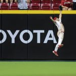 
              Cincinnati Reds' Nick Senzel leaps at the wall to make the catch on a ball hit by Chicago Cubs' Willson Contreras during the ninth inning of a baseball game in Cincinnati, Wednesday, May 25, 2022. The Reds won 4-3. (AP Photo/Aaron Doster)
            