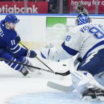 
              Toronto Maple Leafs forward Colin Blackwell (11) tries to cut in on Tampa Bay Lightning goaltender Andrei Vasilevskiy (88) during the second period of Game 1 of an NHL hockey Stanley Cup first-round playoff series in Toronto, Monday, May 2, 2022. (Nathan Denette/The Canadian Press via AP)
            