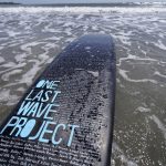 
              A surfboard belonging to Dan Fischer, of Newport, R.I., is covered with names of lost loved ones while resting in the water at Easton's Beach, in Newport, Wednesday, May 18, 2022. Fischer, 42, created the One Last Wave Project in January 2022 to use the healing power of the ocean to help families coping with a loss, as it helped him following the death of his father. Fischer places the names onto his surfboards, then takes the surfboards out into the ocean as a way to memorialize the loved ones in a place that was meaningful to them. (AP Photo/Steven Senne)
            