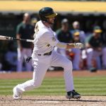 
              Oakland Athletics' Jed Lowrie hits an RBI-single against the Los Angeles Angels during the seventh inning of the first baseball game of a doubleheader in Oakland, Calif., Saturday, May 14, 2022. (AP Photo/Jeff Chiu)
            