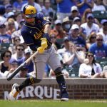 
              Milwaukee Brewers' Luis Urias swing into a three-run home run during the seventh inning in the first game of a baseball doubleheader against the Chicago Cubs Monday, May 30, 2022, in Chicago. (AP Photo/Charles Rex Arbogast)
            