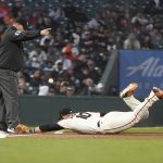 
              San Francisco Giants third baseman Evan Longoria (10) cannot field an RBI-double hit by New York Mets' J.D. Davis during the sixth inning of a baseball game in San Francisco, Monday, May 23, 2022. Pictured at left is third base umpire Jeremy Riggs. (AP Photo/Jeff Chiu)
            