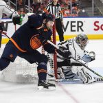 
              Los Angeles Kings goalie Jonathan Quick (32) makes a save against Edmonton Oilers' Leon Draisaitl, front, during the second period of Game 2 of an NHL hockey Stanley Cup playoffs first-round series Wednesday, May 4, 2022, in Edmonton, Alberta. (Jason Franson/The Canadian Press via AP)
            