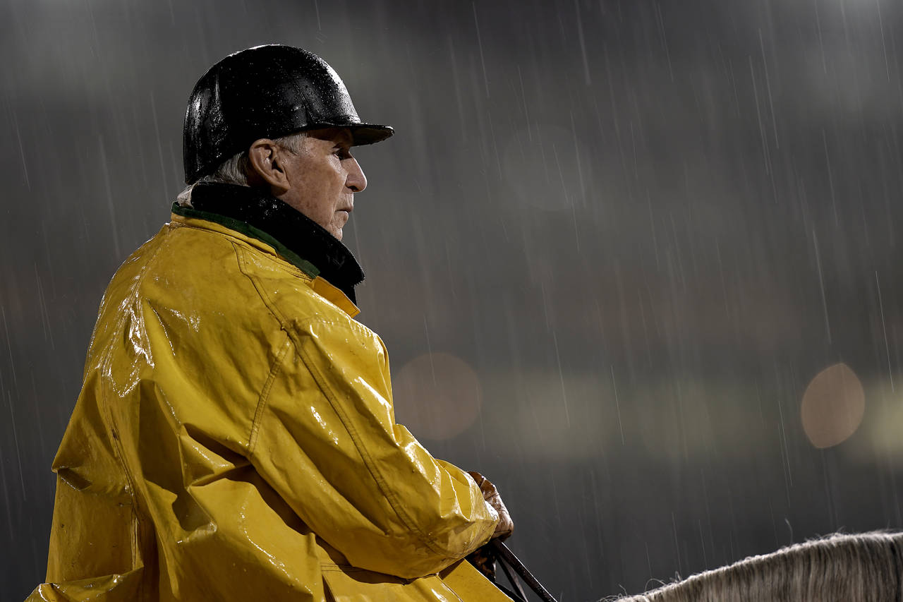Trainer D. Wayne Lukas watches a horse workout in the rain at Churchill Downs Tuesday, May 3, 2022,...