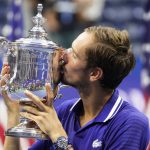 
              FILE - Daniil Medvedev, of Russia, kisses the championship trophy after defeating Novak Djokovic, of Serbia, in the men's singles final of the U.S. Open tennis championships, Sunday, Sept. 12, 2021, in New York. The ATP men’s professional tennis tour will not award ranking points for Wimbledon this year because of the All England Club’s ban on players from Russia and Belarus over the invasion of Ukraine. The ATP announced its decision Friday night, May 20, 2022, two days before the start of the French Open — and a little more than a month before play begins at Wimbledon on June 27. It is a highly unusual and significant rebuke of the oldest Grand Slam tournament. (AP Photo/John Minchillo, File)
            
